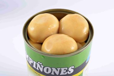 Luz - cogumelos de colocação em latas amarelos, cogumelos de botão inteiros em uns frascos
